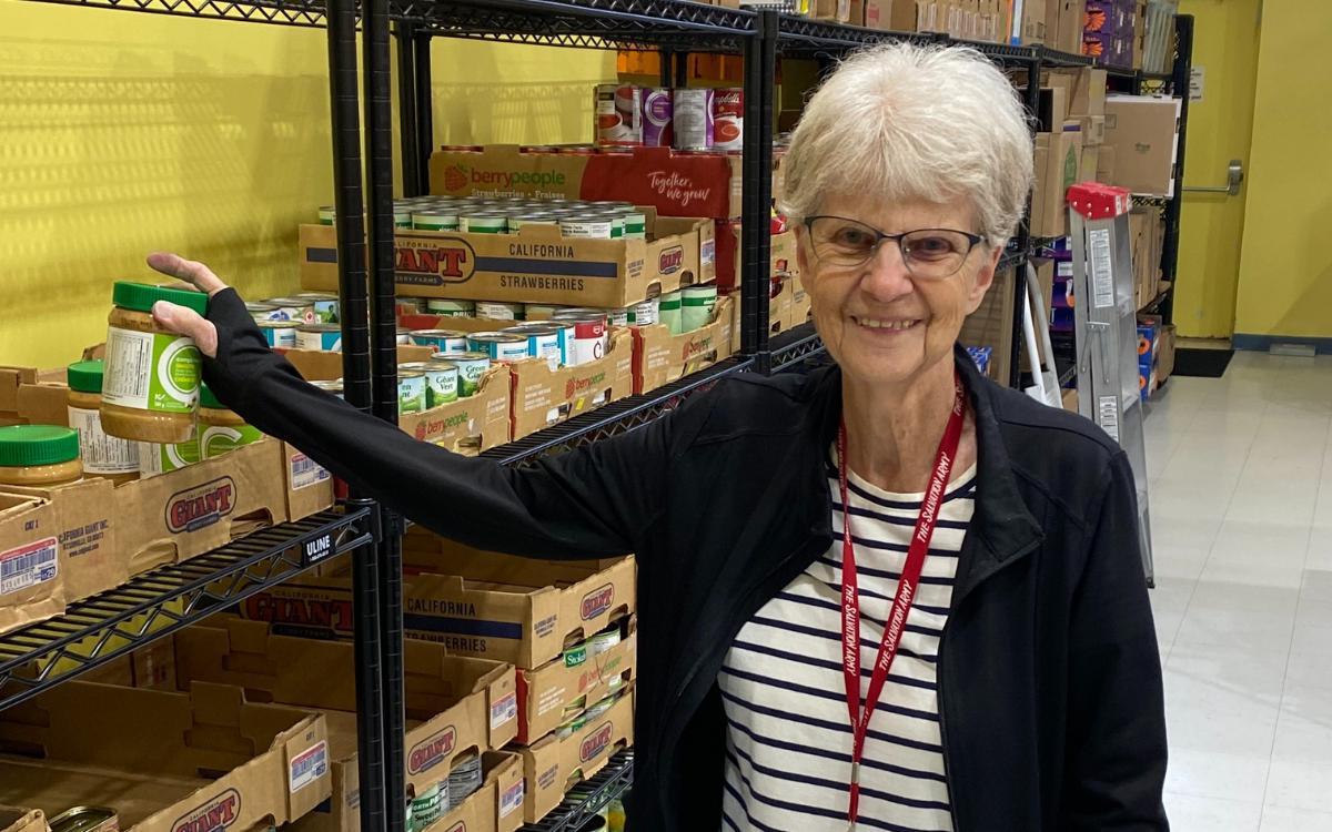 A volunteer picking up a donated peanut butter