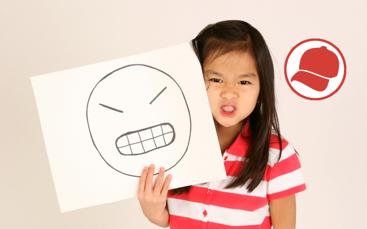 Angry child with drawing of angry face