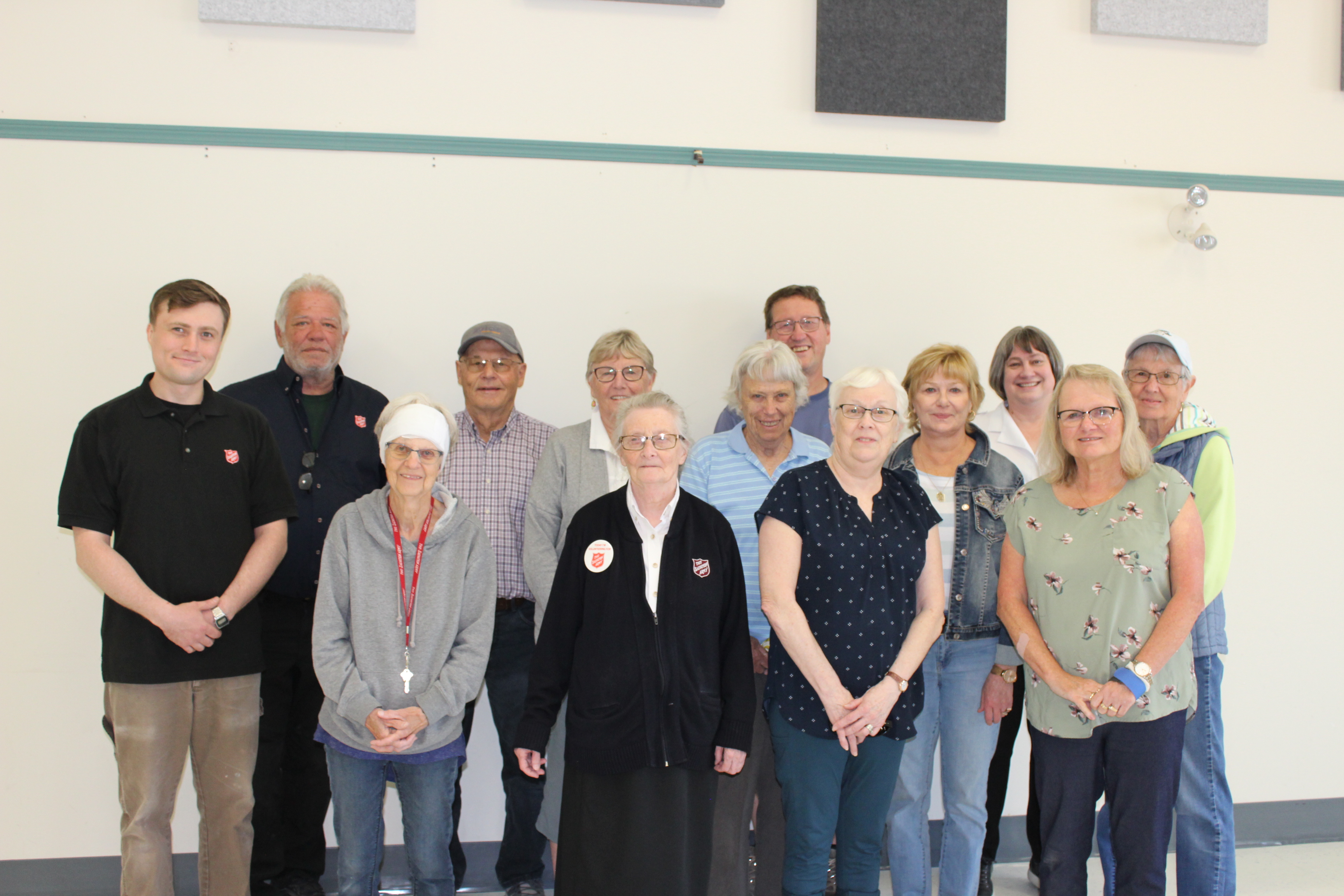 A group of volunteers and employees posing for a picture