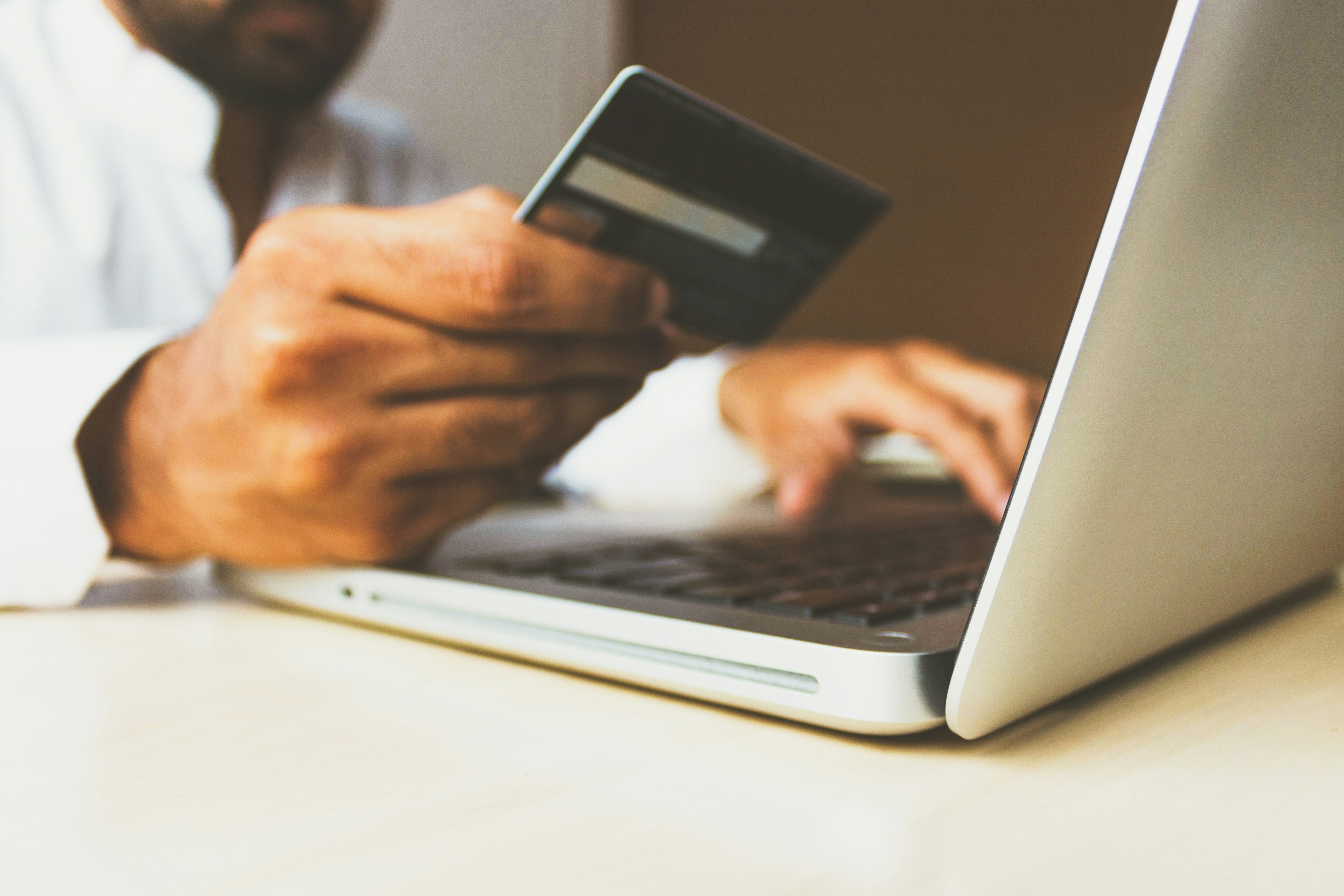 A person holding a credit card for payment